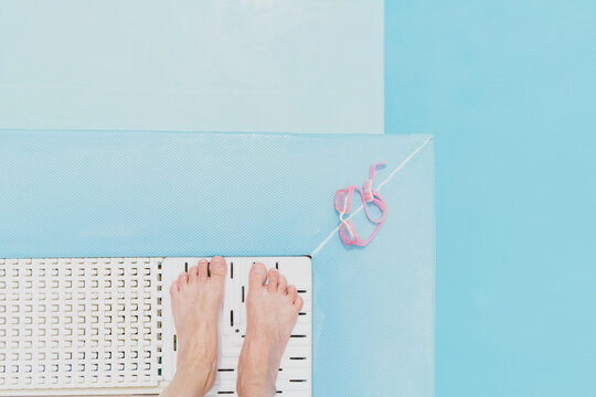 Womans Feet On A Pool Deck