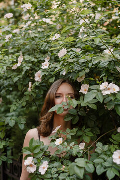 Woman hides in rosehips clumps