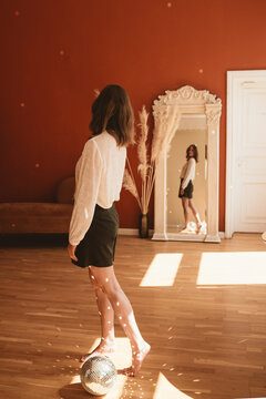 Woman looking at the mirror