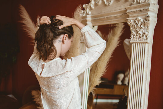 Woman making a pony tail 