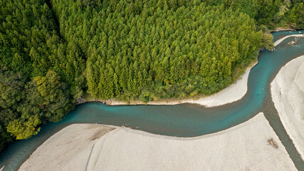 A jade-colored river that forms a large sandbar and flows through the mountains B