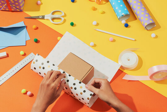 Female Hands Wrapping And Holding Present