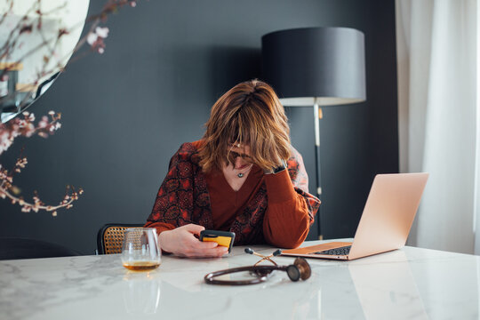 Woman looking at her phone while working