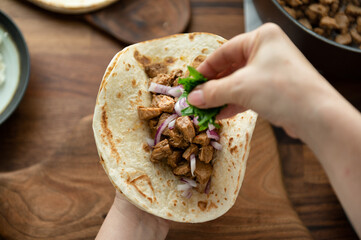 Preparing Mexican tacos pork carnitas