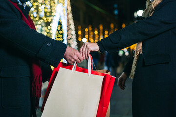 Couple with Christmas presents on street