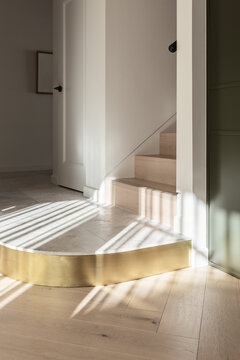 A curved marble and brass step