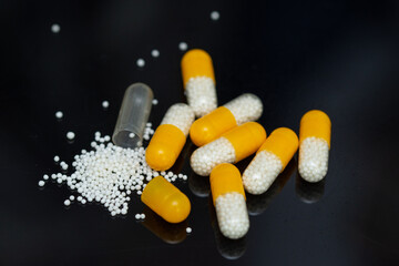 white yellow pills with white granules inside