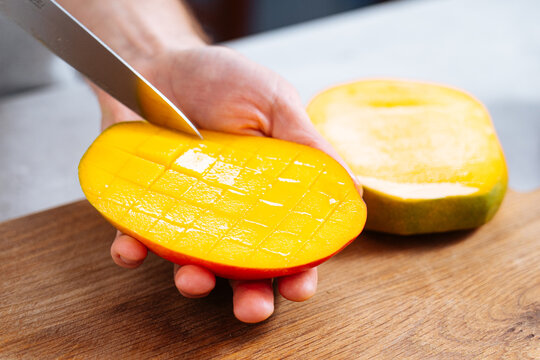 Chef cutting mango