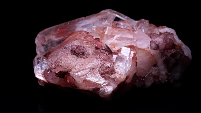 Big Quartz crystals rock in natural appearance, selective focus, found in the Caribbean river water. Crystals cluster close-up, on black surface. The most common mineral and home decoration.