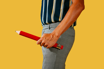 man has a large red pencil in his hand