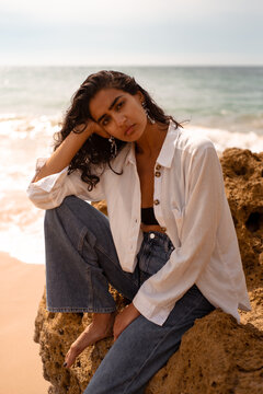 Model posing on the beach for sustainable fashion