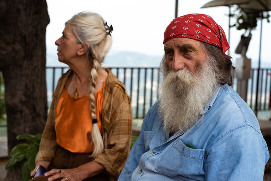 Couple of old friends sitting on a bench in the village
