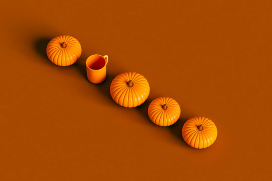 Pumpkins and a mug in a row on brown background