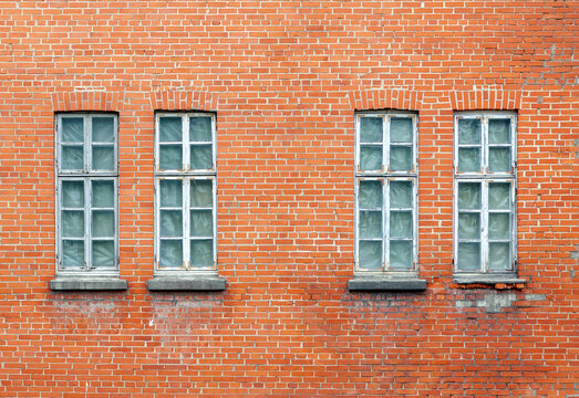 Fototapeta Old red brick wall with four small windows
