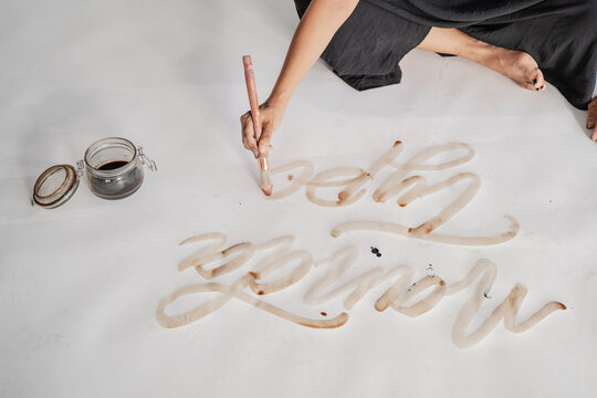 Close up Of Female Artist's Hand Doing Calligraphy 