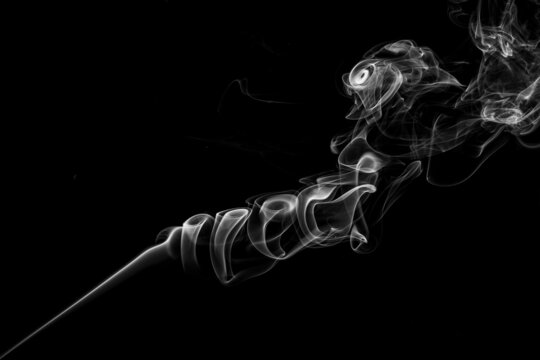 High contrast black and white studio photograph from the hard light strobe project with incent sticks