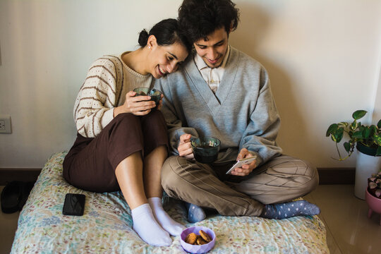 Happy couple having coffee in bed