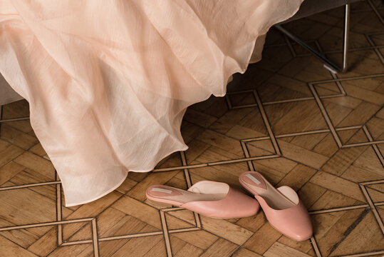 Elegant leather mules on old wooden floor