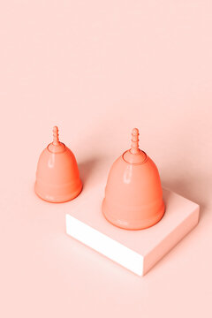period cups on pink background