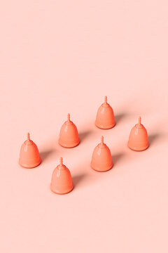 six Menstrual cups on pink background
