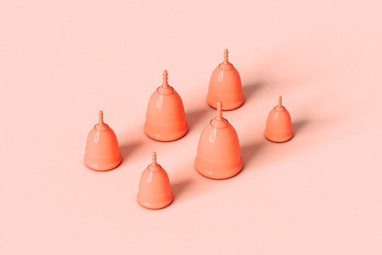 Menstrual cups on pink background in different sizes
