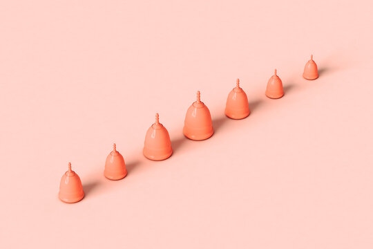 Menstrual cups on pink crossing the frame