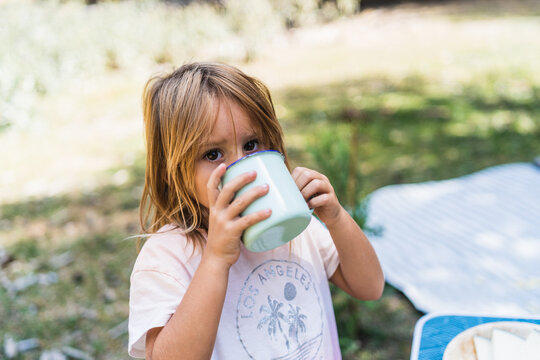 Girl drinking in countryside