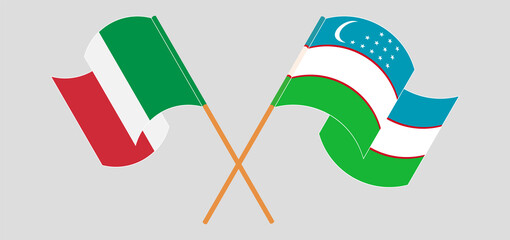 Crossed and waving flags of Italy and Uzbekistan