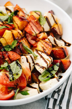 Balsamic reduction over peach Caprese