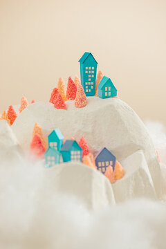 Clouds drift across the mountain with multicolored paper houses