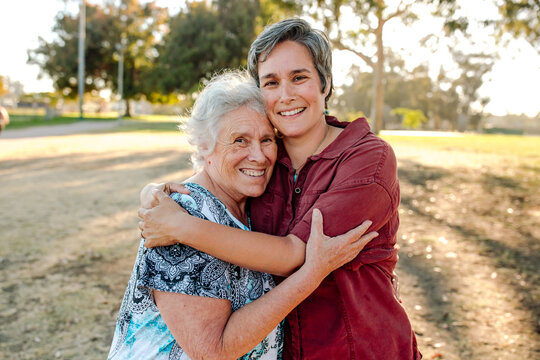 Happy Adult Woman Hugging Elderly Mom