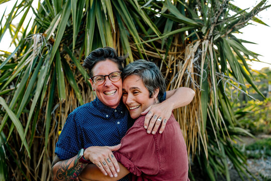 Joyful lesbian couple embracing outdoors