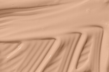 Beige nude liquid foundation texture, concealer smear smudge drop. Make up base, cream textured background. Closeup macro. Cosmetic tonal makeup moisturizer, bb cream swatch sample.
