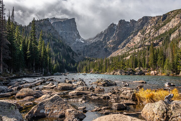 View of dream lake surrounded by mountains in rocky mountain national park, colorado. The lake has...