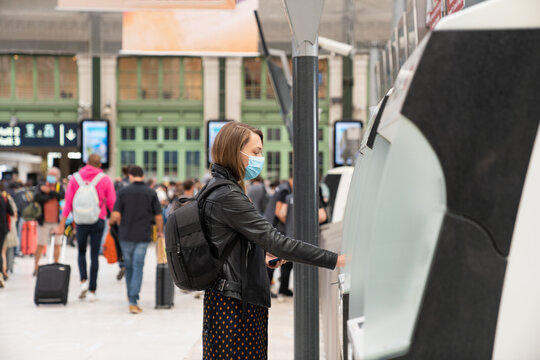 Woman Buying Ticket In Station
