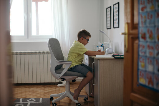 Boy Doing Homework in his Room