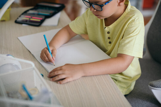 Boy Doing Homework in his Room