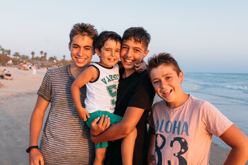 Delighted brothers embracing on beach