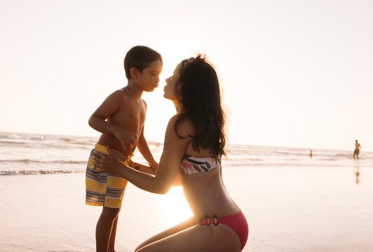 Mother and child kissing on beach