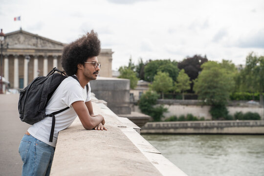 Man Enjoying View From The Bridge Of Paris