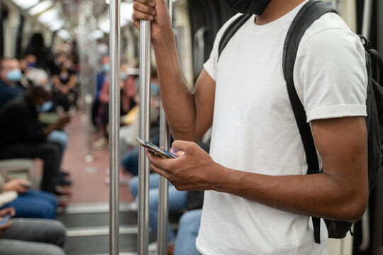 Anonymous Man Using Cellphone In Metro