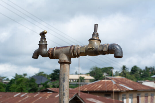 Old rusted and broken public water tap