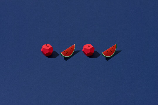 origami watermelon and apple on blue paper
