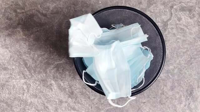 Black trash can full of used masks. to prevent coronavirus That is spreading around the world. Wearing a mask is one way to help prevent the spread of germs in the general public throughout our world.