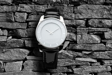 Men watch breaks rocks, advertising product conceptual