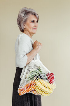 Ages woman with groceries in eco bag