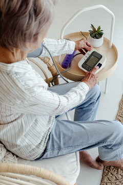 Anonymous senior woman checking blood pressure
