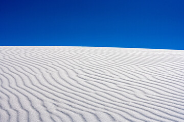 Fototapeta na wymiar Wind Blown Ripples Sit Untouched On Sand Dune