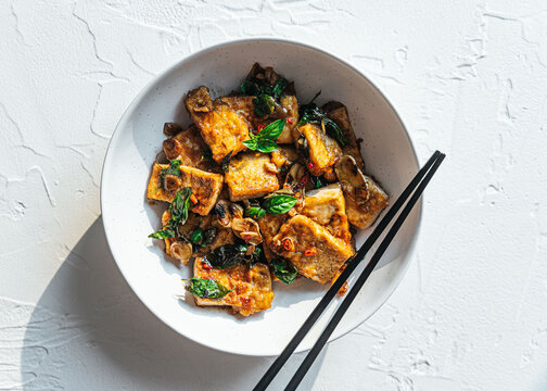 Vegan tofu stir fry in ceramic bowl