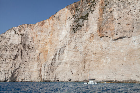 white cliff and boat on mediterranean sea coast, Greece